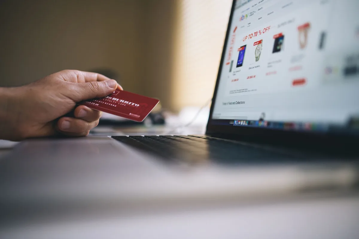 Malaysian Shopee seller setting up e-invoicing with laptop and business documents at desk