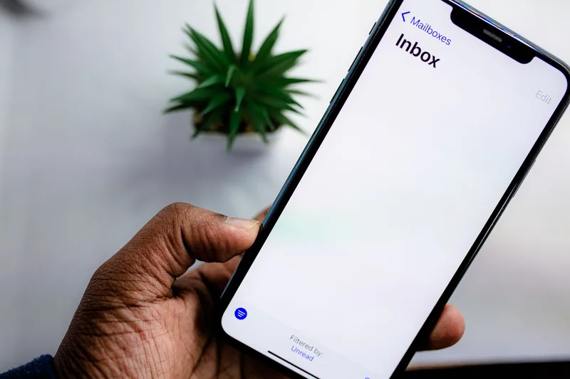 Smartphone showing email inbox with account confirmation notification