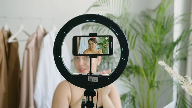 Person showcasing a product on camera during a live streaming session